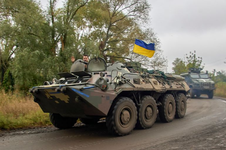 Ukrainian serviceman waves from an armoured personnel carrier
