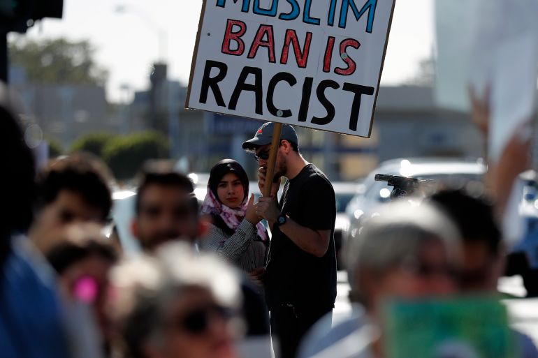 People demonstrate against a ruling by the US Supreme Court upholding President Trump's travel ban on people from mostly Muslim countries