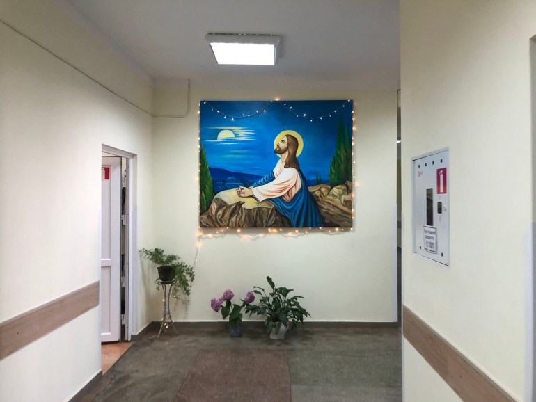 A photo of the outside of Dr Lykhach's office with a painting of Jesus on the wall next to it.