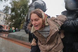 Russian policemen detain a woman during a protest against Russia&#39;s military mobilisation for the war in Ukraine [Maxim Shipenkov/EPA-EFE]
