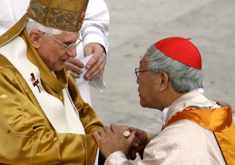 Pope Benedict XVI (L) gives a ring to new cardinal Joseph Zen Ze-Kiun during Mass in St Peter's Square, Saturday 25 March 2006 i