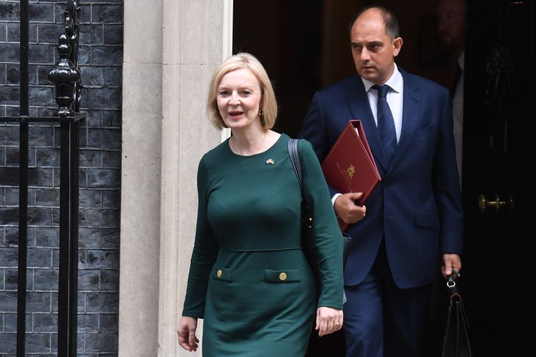 Britain's Prime Minister Liz Truss (L) departs her official residence at 10 Downing Street in London