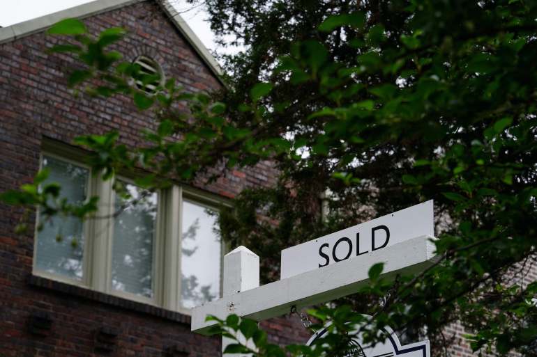 One "sold" Signs are seen outside a newly purchased home in Washington, USA