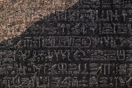 A close-up view of the cartouche of the Ptolemaic dynasty Pharaoh Ptolemy V Epiphanes inscribed with the rest of the ancient Egyptian hieroglyphic text in the upper portion of the Rosetta Stone, on display at the British Museum in London on July 26, 2022 [File: Amir Makar/AFP]