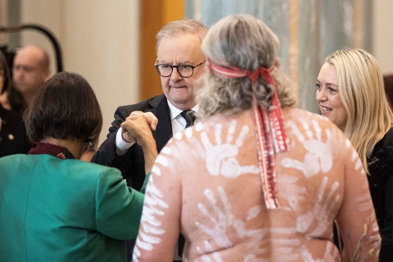 Australian Prime Minister Anthony Albanese (c) greets Indigenous elders at the National Memorial to Queen Elizabeth II