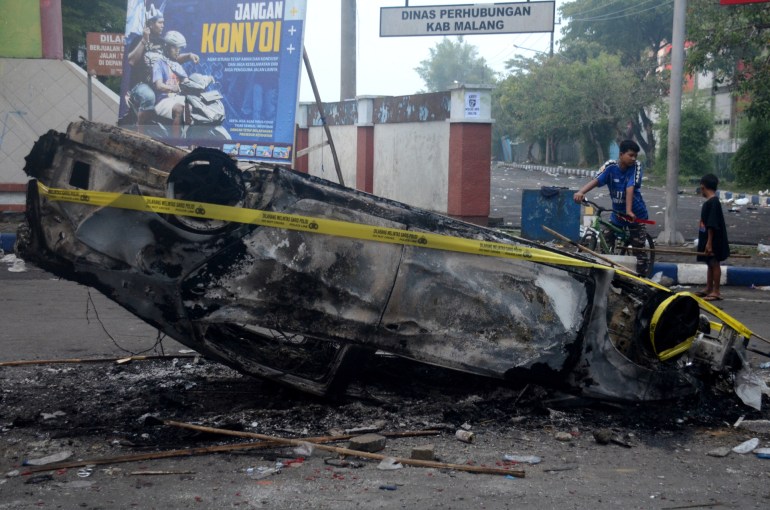 This photo shows a burned car outside Kanjuruhan Stadium in Malang, East Java on October 2, 2022.