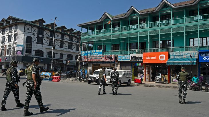 Indian paramilitary troopers patrol along a street in Srinagar