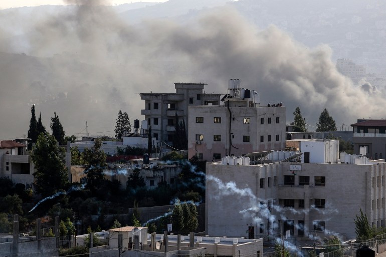 Smoke rises in the West Bank village of Deir al-Hatab east of Nablus, during ongoing confrontations between Palestinians and Israeli security forces