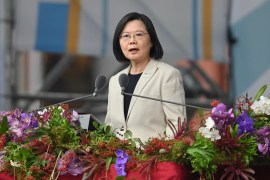 Tsai Ing-wen speaks at a lectern which is decorated with greenery and flowers