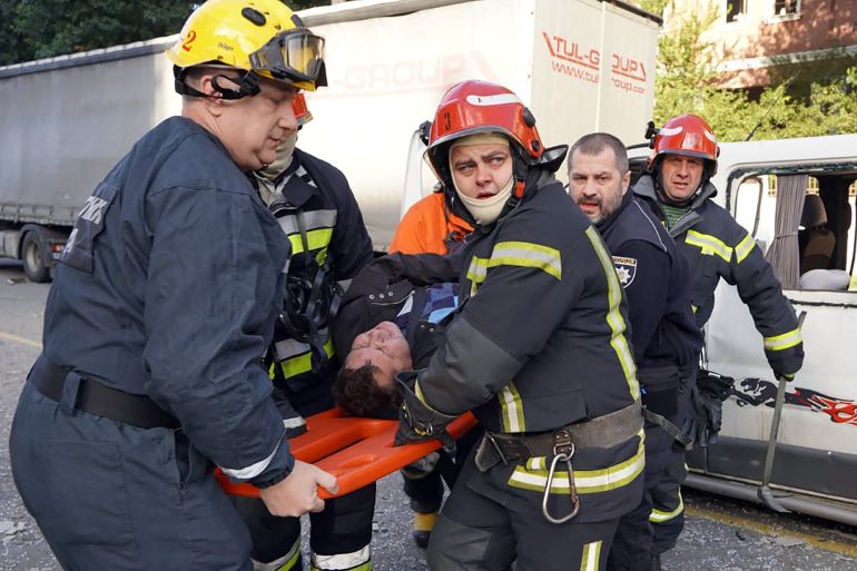 rescuers carrying an injured man
