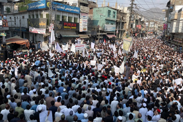 Residents take part in a protest a day after an attack on a school bus in Mingora