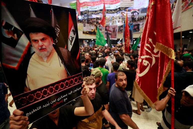 (FILES) In this file photo taken on August 2, 2022, supporters of Iraqi cleric Moqtada Sadr (image), protest against a rival bloc's nomination for prime minister, in the capital Baghdad's high-security Green Zone. - The movement led by firebrand cleric Moqtada Sadr announced today its refusal to be part of the upcoming government set to be formed by Mohammad Shia al-Sudani. (Photo by AHMAD AL-RUBAYE / AFP)