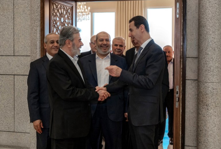 This handout picture released by the Syrian Presidency, shows Syia's President Bashar al-Assad (R) receiving Hamas chief of Arab relations, Khalil al-Hayya (C) and the leader of Palestinian militant group Islamic Jihad, Ziad al-Nakhala (L) in the capital Damascus, on October 19, 2022.
