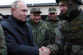 Russian President Vladimir Putin and Defence Minister Sergey Shoigu meet soldiers during a visit at a military training centre of the Western Military District for mobilised reservists, outside the town of Ryazan on October 20, 2022 [Mikhail Klimentyev/Sputnik via AFP]