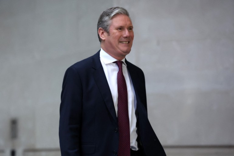 Britain's main opposition Labour Party leader Keir Starmer smiles