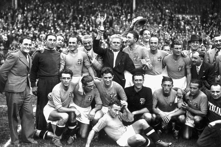 Italy's national soccer team poses with the World Cup trophy after beating Hungary 4-2 in the World Cup final