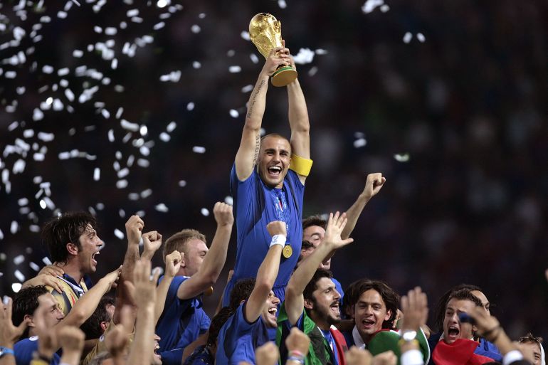 Italian defender Fabio Cannavaro (C) celebrates with the trophy after the World Cup 2006 final football game Italy vs.France, 09 July 2006 at Berlin stadium