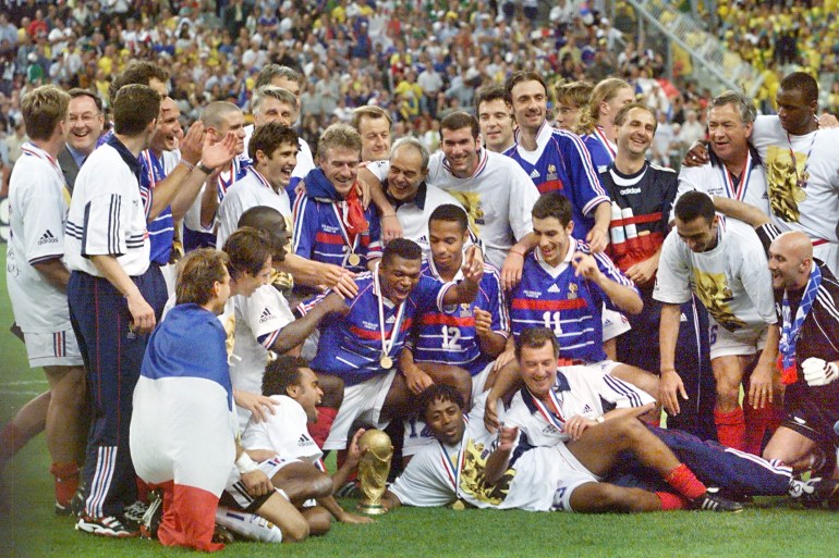 The French team celebrates with the FIFA trophy 12 July at the Stade de France in Saint-Denis, after France defeated Brazil 3-0 in the 1998 World Cup final.