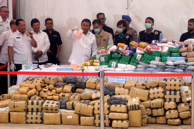 National Anti-Narcotics Agency officials show packages of illicit drugs seized by Indonesian police.