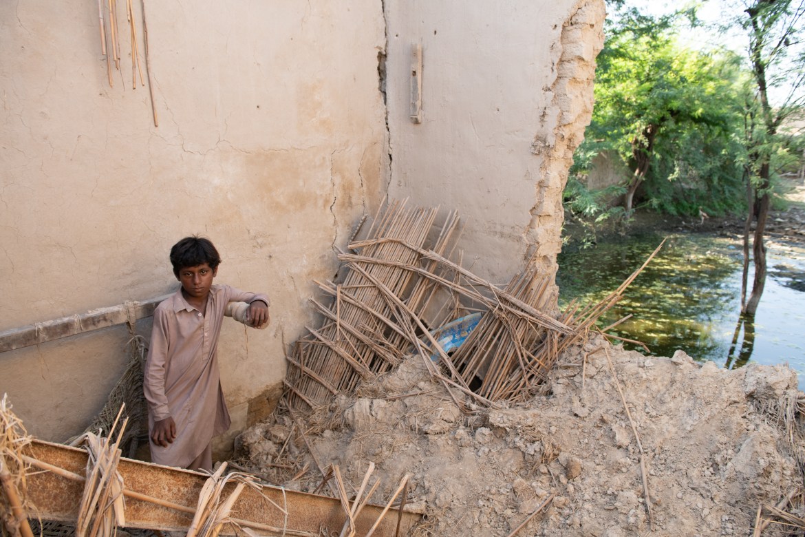 Kasim’s son Babar stands in the debris of their destroyed home whose backyard is still flooded. Water-borne diseases, such as diarrhea, malaria and gastroenteritis in flooded areas are a grave concern.