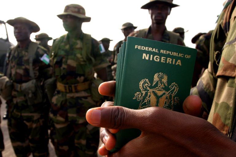 A Nigerian officer holds passports for his troops