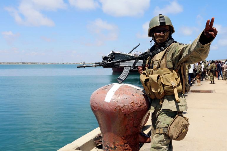A Somali military officer guards the dock at the southern port city of Kismayu