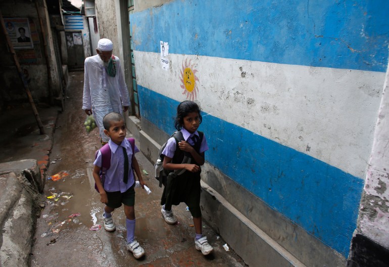 People pass wall paint with the flag of Argentina, participant in the 2014 World Cup, in Dhaka, May 28, 2014. Millions of Bangladeshi football fans mainly support the national football teams of Argentina and Brazil. 