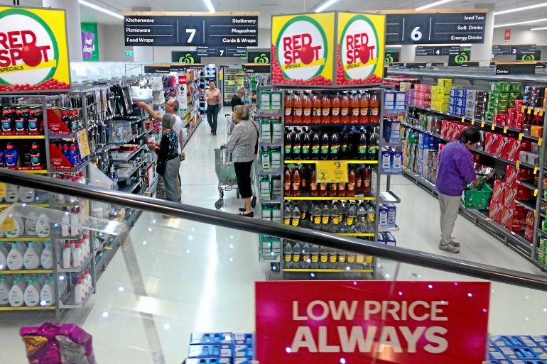 Australian Coles supermarket, showing aisles and a red sign at the front that says "Lower Price ALWAYS"