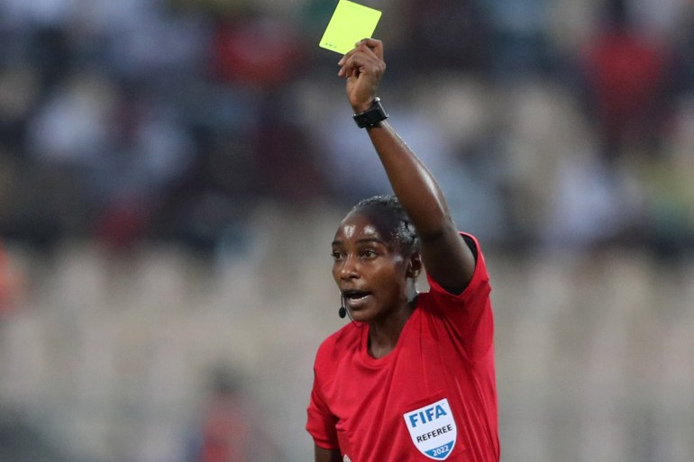Referee Salima Mukansanga shows a yellow card to Zimbabwe's Talbert Shumba REUTERS/Mohamed Abd El Ghany
