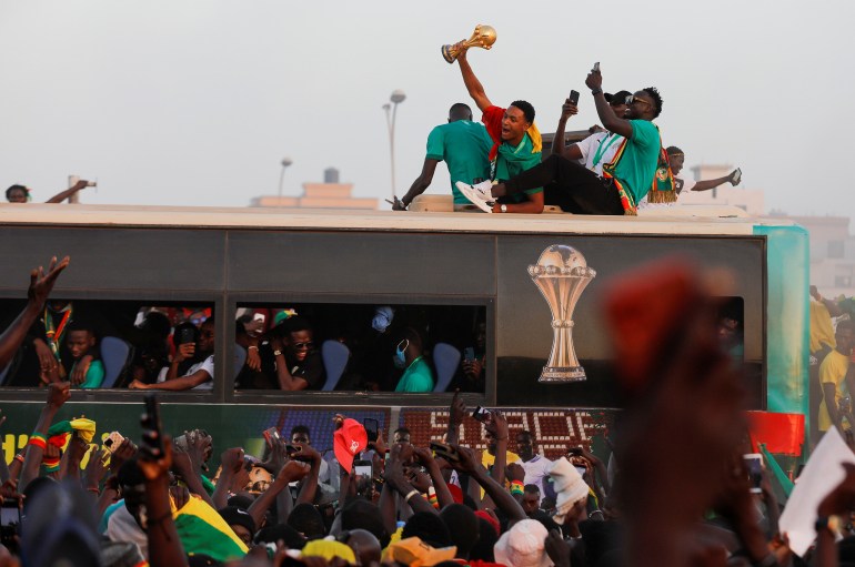 Members of the Senegal National Soccer Team celebrate their arrival on a bus after their Africa Cup victory, in Dakar, Senega