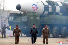 North Korean leader Kim Jong Un walks in front of an intercontinental ballistic missile in March, 2022.