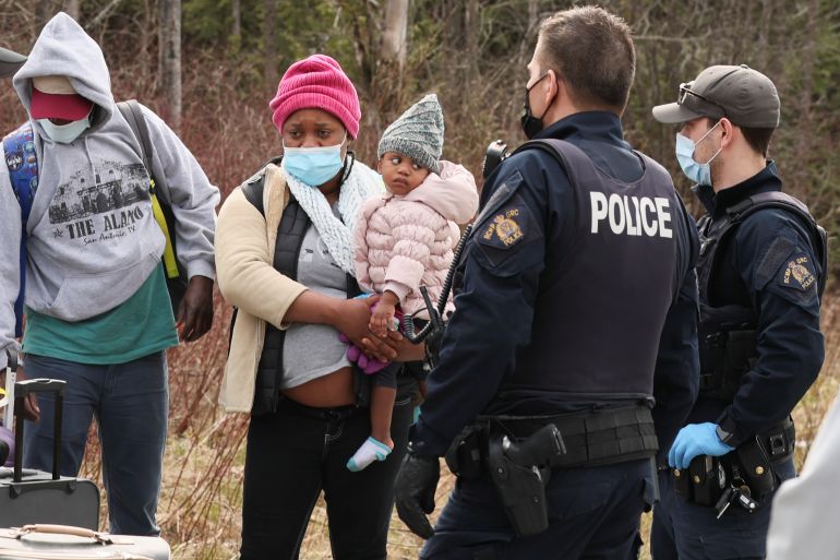 Asylum seekers cross into Canada from the US border