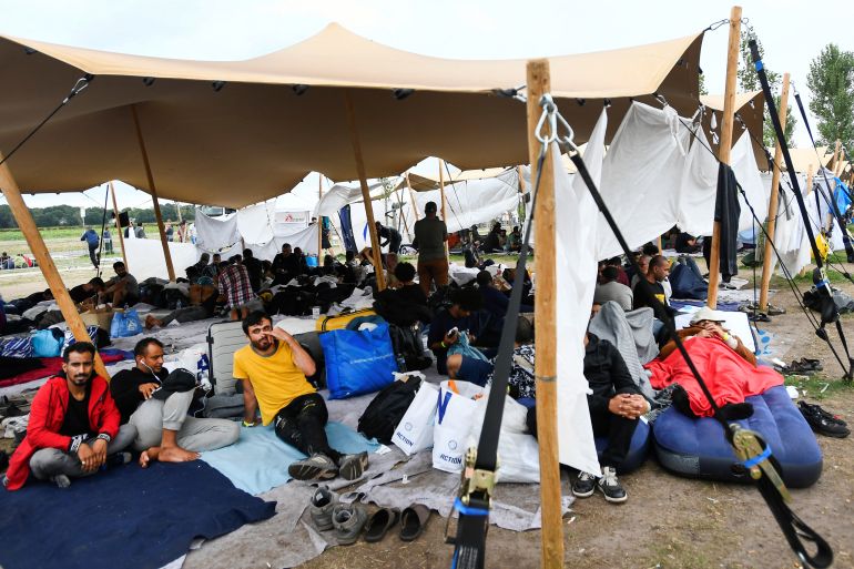 Refugees wait outside at the main reception centre for asylum seekers, in Ter Apel, Netherlands August 26, 2022. REUTERS/Piroschka van de Wouw
