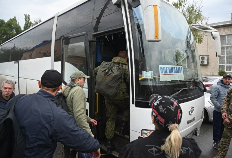 Reservists drafted during partial mobilisation board a bus as they depart for military bases, in the city of Bataysk in the Rostov region, Russia September 26, 2022.