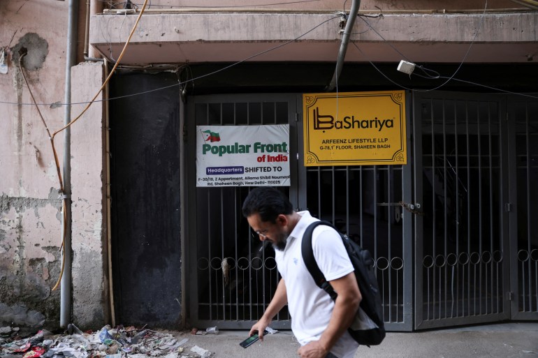 A man walks past the old office of Popular Front of India in Nwew Delhi.