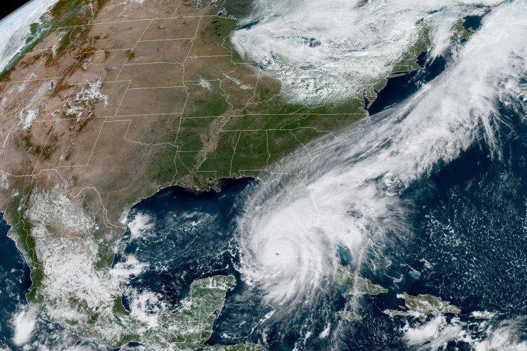 Hurricane Ian makes its way to Florida's west coast after passing Cuba in a composite image from the National Oceanic and Atmospheric Administration (NOAA) GOES-East weather satellite September 27, 2022.
