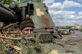 A Ukrainian soldier looks out from a tank in the front-line city of Lyman, Donetsk region, Ukraine on April 28, 2022 [File: Jorge Silva/Reuters]