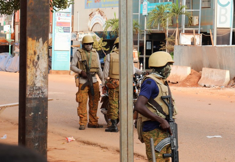 New Junta soldiers stand guard on a street in Ouagadougou, Burkina Faso