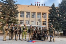 Ukrainian armed forces make a statement in front of Lyman Town Administration office, in Lyman, Ukraine, in this still image taken from a social media video, released on October 1, 2022 [Courtesy of 81 Airborne Brigade of the Ukrainian Armed Forces/via Reuters]