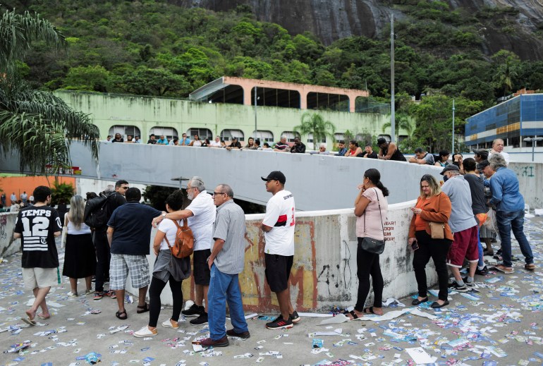 People line up to vote outside a polling station, in Rio de Janeiro