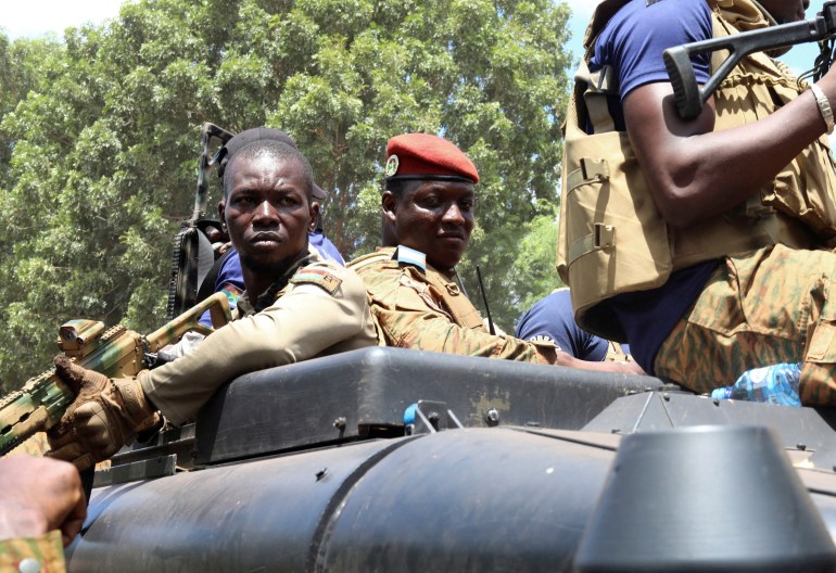 Burkina Faso's new military leader Ibrahim Traore is escorted by soldiers while he stands in an armoured vehicle in Ouagadougou, Burkina Faso October 2, 2022.