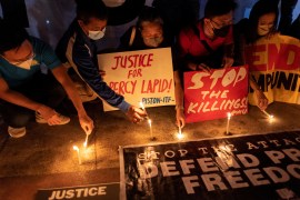 Journalists and activists light candles for killed Filipino radio journalist Percival Mabasa during an indignation rally, in Quezon City, Philippines, October 4, 2022.