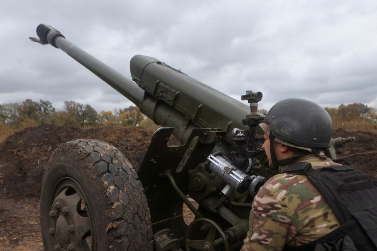 A Ukrainian soldier prepares a D-30 howitzer for a fire in Kharkiv.