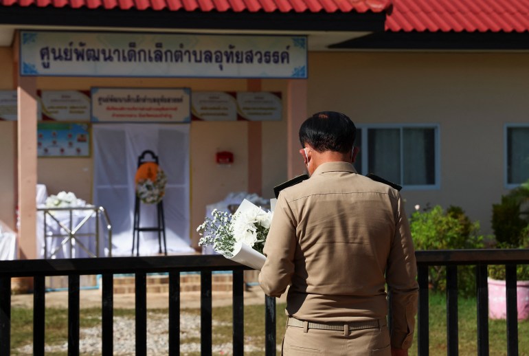 Thailand's Prime Minister Prayut Chan-o-cha pays his respects outside the day care centre which was the scene of a mass shooting, in the town of Uthai Sawan, around 500 km northeast of Bangkok, in the province of Nong Bua Lam Phu, Thailand October 7, 2022. REUTERS/Athit Perawongmetha