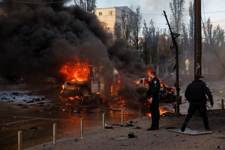 Cars are seen on fire after Russian missile strikes in Kyiv