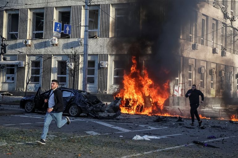 Cars burn after Russian military strike, as Russia's invasion of Ukraine continues, in central Kyiv.