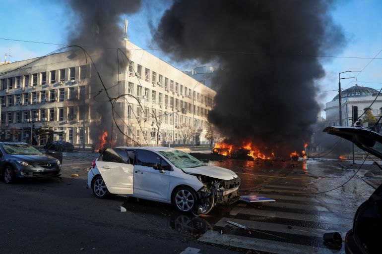 Cars burn after Russian military strike in Kyiv.