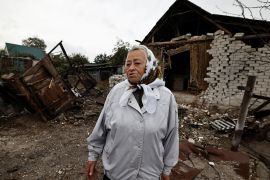 Anna Andriivna stands beside her summer kitchen, that according to her was hit by a rocket during fighting between Russian troops and Ukrainian army, amid Russia's attack on Ukraine, in the newly recaptured town of Yarova, in Donetsk region