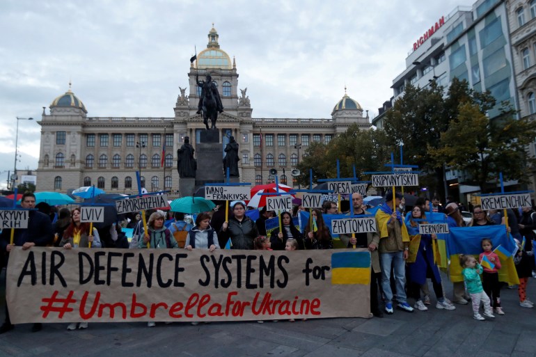 Protesters in Prague hold banner saying 'Air defence systems for Ukraine #UmbrellaforUkraine'
