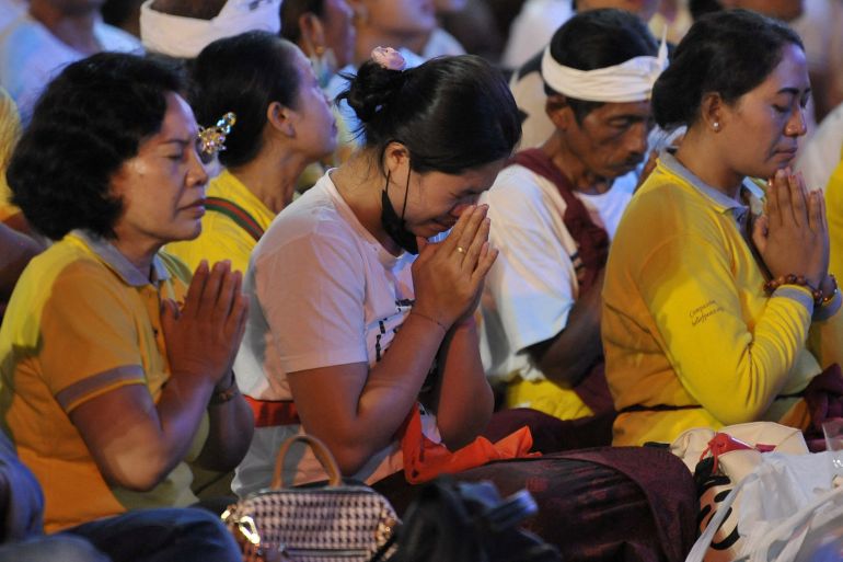 Men and women pray as they remember those who were killed in the Bali bombings 20 years ago
